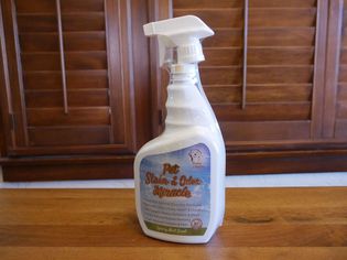 Sunny & Honey Pet Stain & Odor Miracle bottle displayed on a wooden table