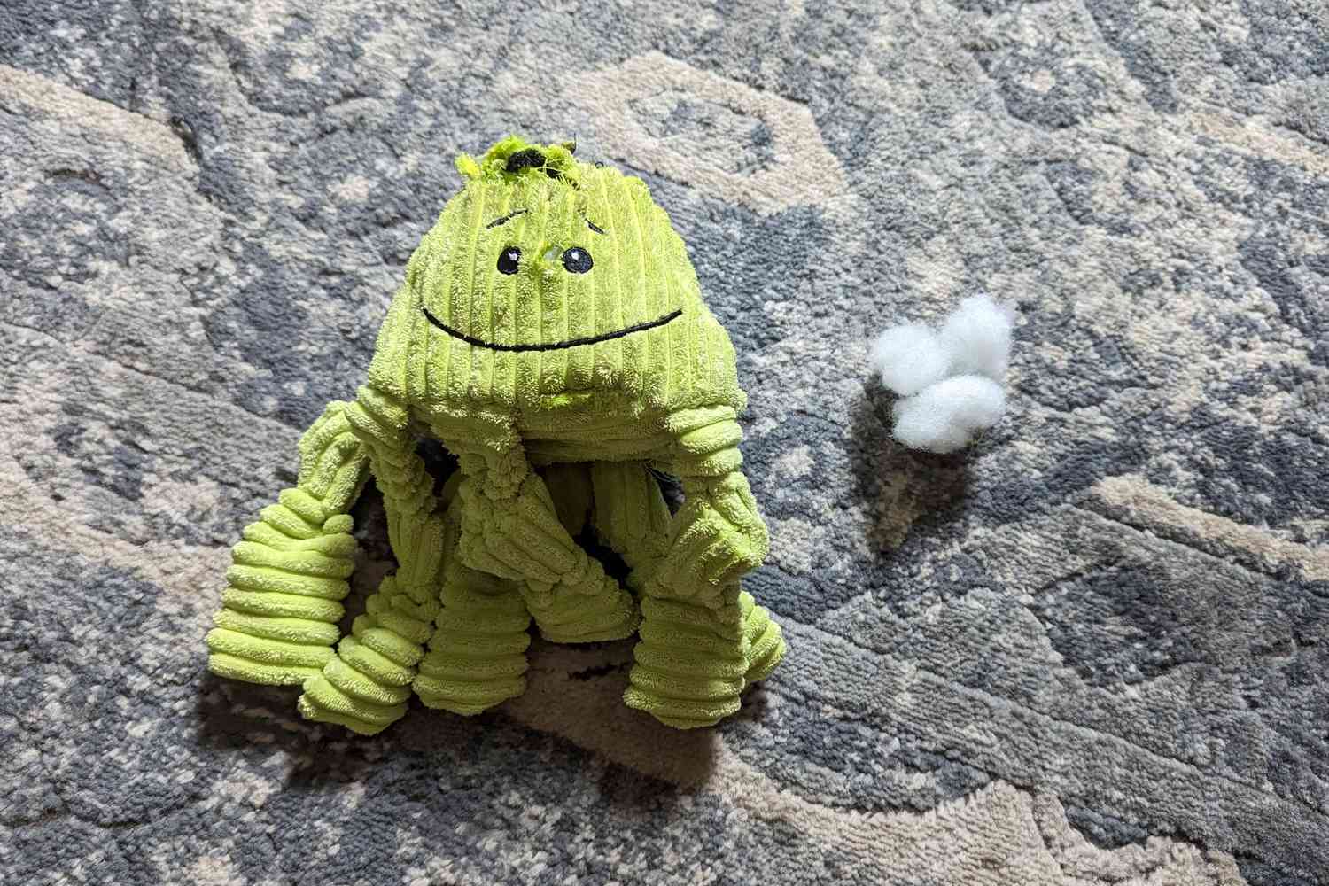 The HuggleHounds Knotties Dog Toys on the carpet with some stuffing