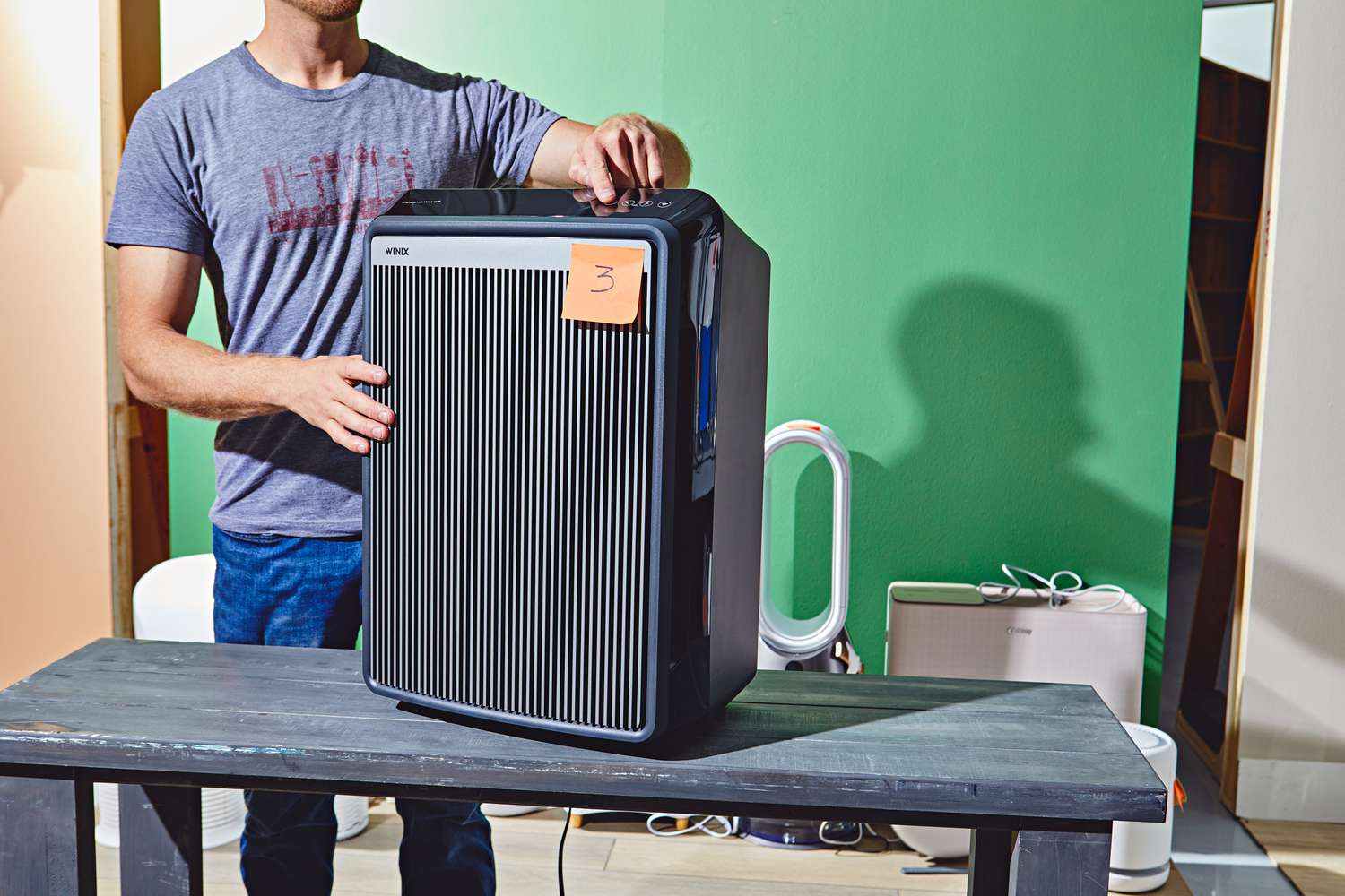 Person turning on the winix air purifier