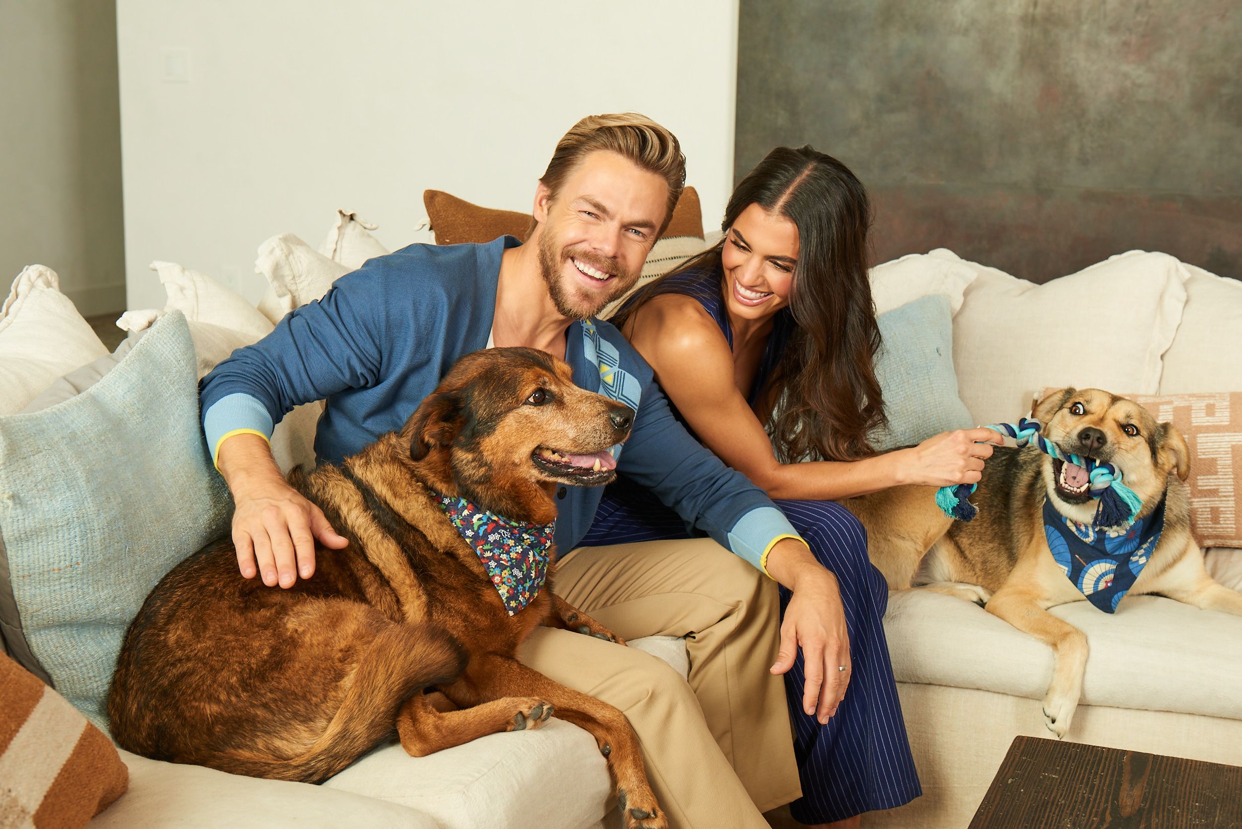Derek Hough and Hayley Erbert-Hough on couch with two dogs